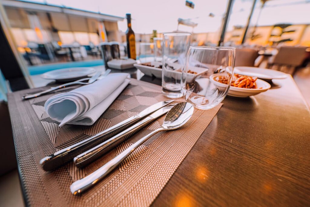 Restaurant table setting with silverware and glasses